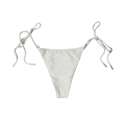 Cream Aláti Paraiso tie-side bikini bottom, back flat-lay, with knotted side ties and narrow rear panel